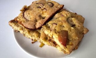 Кусочки шарлотки с яблоками и грушей на белой тарелке